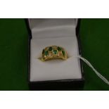 An 18ct yellow gold, diamond and emerald ring of a stylish design, size J.