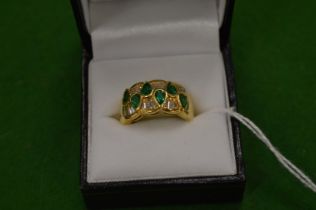 An 18ct yellow gold, diamond and emerald ring of a stylish design, size J.