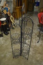 A wrought iron plant stand.