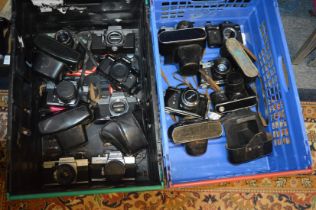 A collection of 35mm camera bodies, some with lenses to include Minolta, Praktica, Zenit etc.