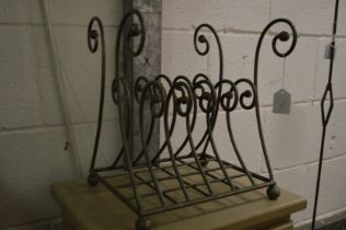 A wrought iron magazine rack.