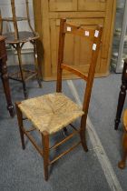 An Arts and Crafts oak and rush seated chair (faults).