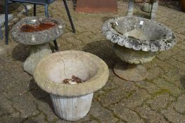 Two reconstituted stone planters and a bird bath.
