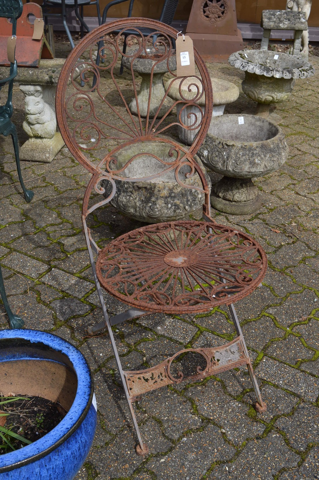 A wrought iron folding garden chair.