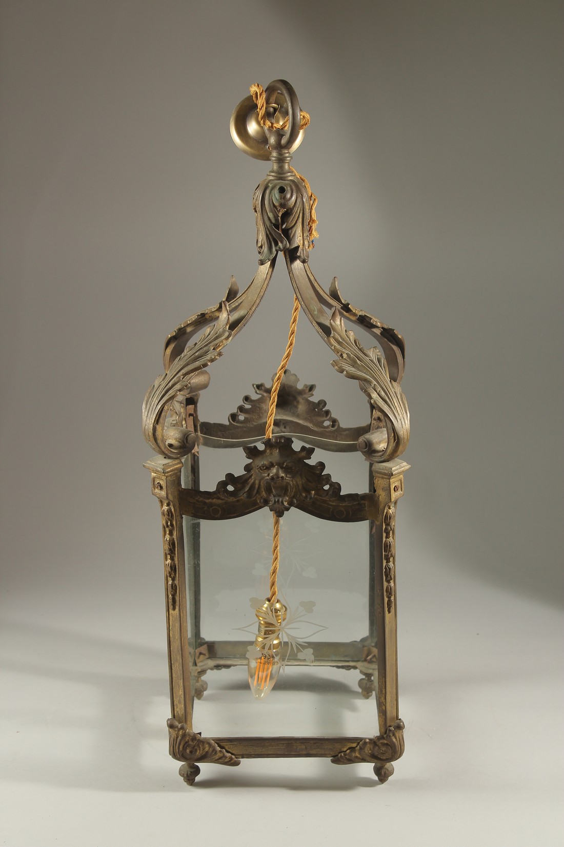 A 19TH CENTURY GILT METAL SQUARE LANTERN with etched glass panels, acanthus leaves and masks.