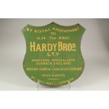 A GREEN HARDY BROS SHIELD SHAPED FISHING SIGN.