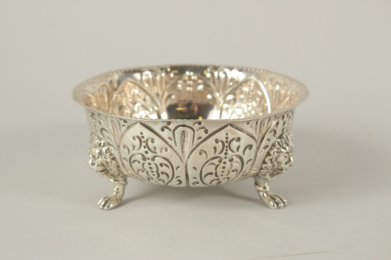 A VICTORIAN CIRCULAR SUGAR BOWL with repousse decoration. 5ins diameter. London 1891.
