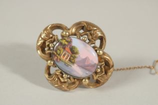 A VICTORIAN 9CT GOLD BROOCH with an oval porcelain Swiss enamel panel, boxed.