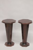 A PAIR OF ART DECO DESIGN WOODEN STANDS with octagonal tops. 2ft 6ins high.
