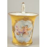 A GOOD DRESDEN CUP with yellow ground, painted with an oval of a cupids. Dresden in gold M.M.S.
