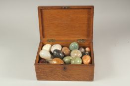 A WOODEN BOX with twenty-eight various mineral eggs.