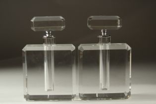 A PAIR OF CUT GLASS SQUARE PERFUME BOTTLES AND STOPPERS. 25cms high.