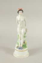 A MEISSEN FIGURE OF A STANDING WOMAN RESTING ON A FENCE. A circle of geese around the base. Modelled