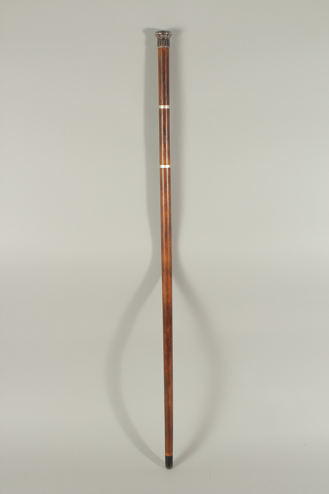 A RARE 19TH CENTURY WALKING STICK with metal top and two screw off sections revealing a long glass