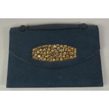 A RENAUD PELLEGRINO, PARIS, BLUE LEATHER BAG, the front with gold metal motifs, with carrying