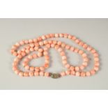 A PINK CORAL COLOURED NINETY BEAD NECKLACE. 80cms long.
