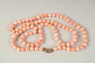 A PINK CORAL COLOURED NINETY BEAD NECKLACE. 80cms long.