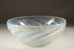A LALIQUE CIRCULAR BOWL with spiral of fishes. 9.5cms diameter. Etched: R. Lalique, France.