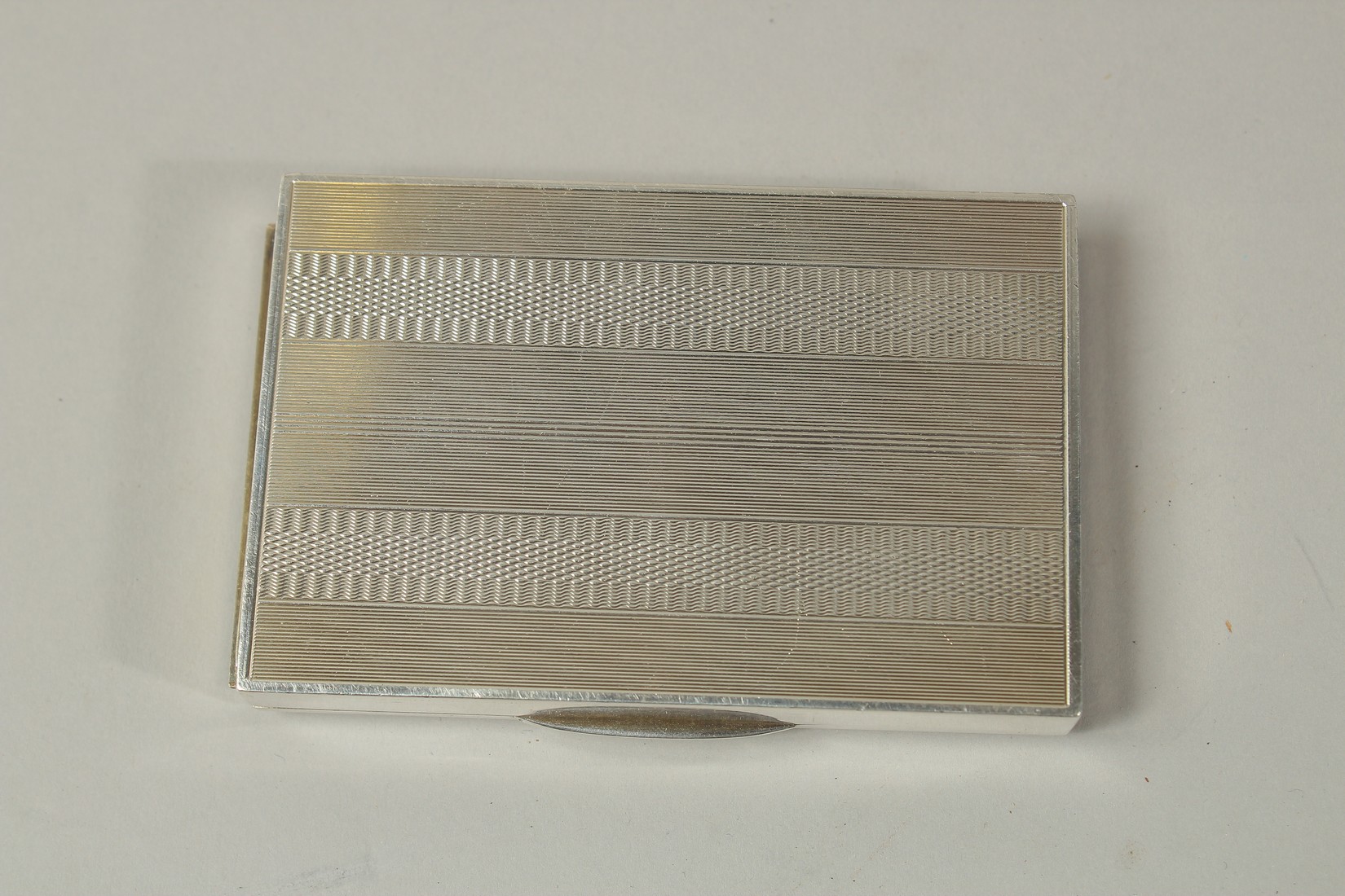 A CONTINENTAL SILVER CIGARETTE CASE with engine turned decoration, the interior of the lid revealing - Image 3 of 3