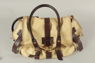 AN YVES SAINT LAURENT, PARIS, SOFT LEATHER BAG with metal clips and leather handles. 40cms long.
