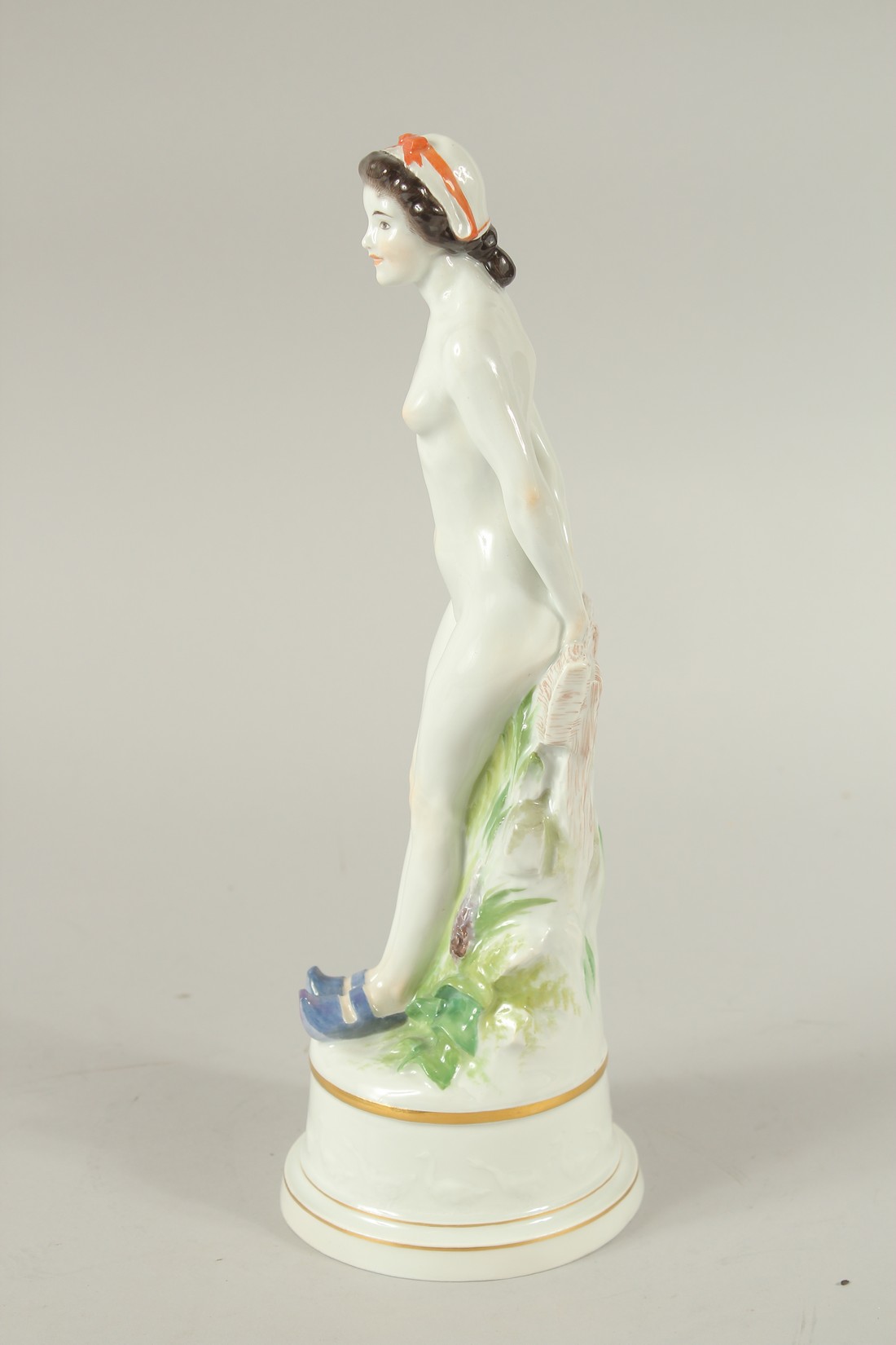 A MEISSEN FIGURE OF A STANDING WOMAN RESTING ON A FENCE. A circle of geese around the base. Modelled - Image 4 of 6