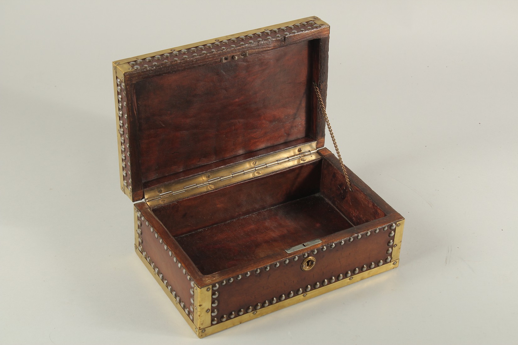 A BRASS BANDED AND STUDDED LEATHER BOX. 10ins long x 4ins high x 6ins deep. - Image 2 of 5