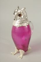 A GOOD SILVER PLATE AND CRANBERRY GLASS OWL CLARET JUG.