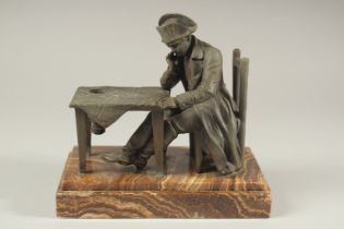 NAPOLEON SITTING AT A TABLE, spelter on an onyx base. 9ins high.