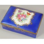 A SEVRES PORCELAIN BOX AND COVER with blue ground, with a panel of flowers. 5ins long.
