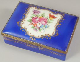 A SEVRES PORCELAIN BOX AND COVER with blue ground, with a panel of flowers. 5ins long.