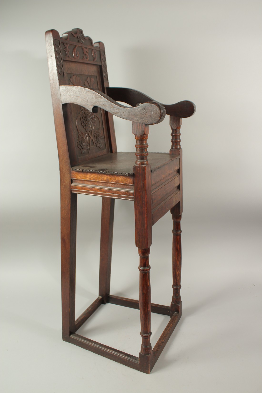 A CHILD'S 17TH CENTURY HIGH CHAIR, dated 1659, with carved back and solid seat. 3ft 6ins high x - Image 3 of 4