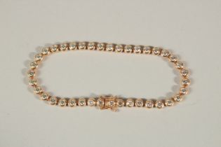 A 9CT ROSE GOLD DIAMOND LINE BRACELET. Approc. 5ct of diamonds.