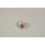 AN 18CT WHITE GOLD, DIAMOND AND ORANGE SAPPHIRE RING, size N.
