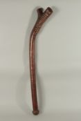 A LARGE HEAVY WOODEN CLUB with etched handle. 39ins long.