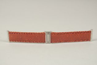 A BOUCHERON TAN STRAP in a Boucheron case. 14cms long.