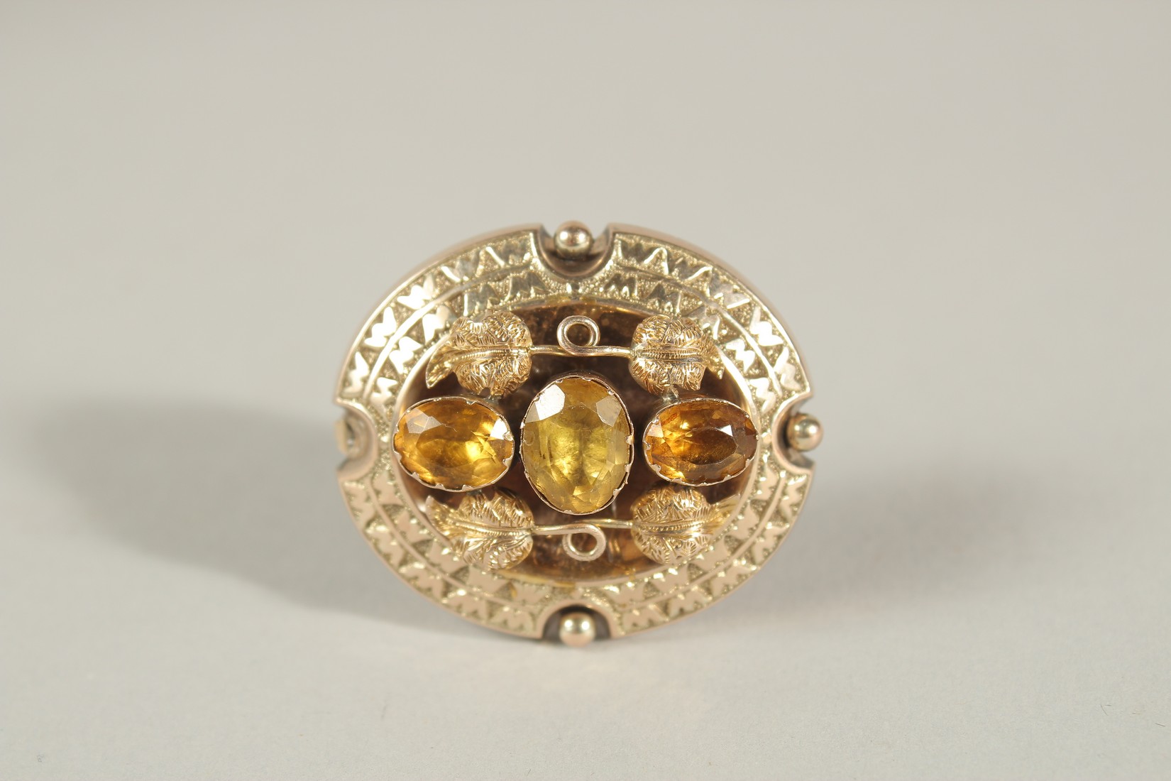 A VICTORIAN 9CT GOLD LOCKET BACK CITRINE BROOCH.