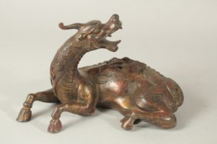 A BRONZE FIGURAL BEAST-FORM CENSER, with traces of gilt and red paint. 27cms long.