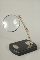 A MAGNIFYING GLASS on a stand.