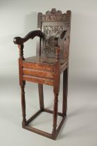 A CHILD'S 17TH CENTURY HIGH CHAIR, dated 1659, with carved back and solid seat. 3ft 6ins high x