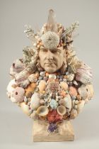 A GROTTO POTTERY POSEIDON BUST OF A MAN covered in various shells. 14ins high.
