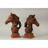 A PAIR OF CAST IRON HORSE'S HEADS. 40cms high.