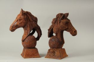 A PAIR OF CAST IRON HORSE'S HEADS. 40cms high.