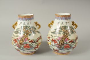 A PAIR OF CHINESE PORCELAIN TWO HANDLED VASES, deer in a landscape. 23cms high.