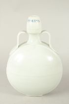 A CHINESE WHITE GLAZE PORCELAIN TWIN HANDLE MOON FLASK. 30cms high.