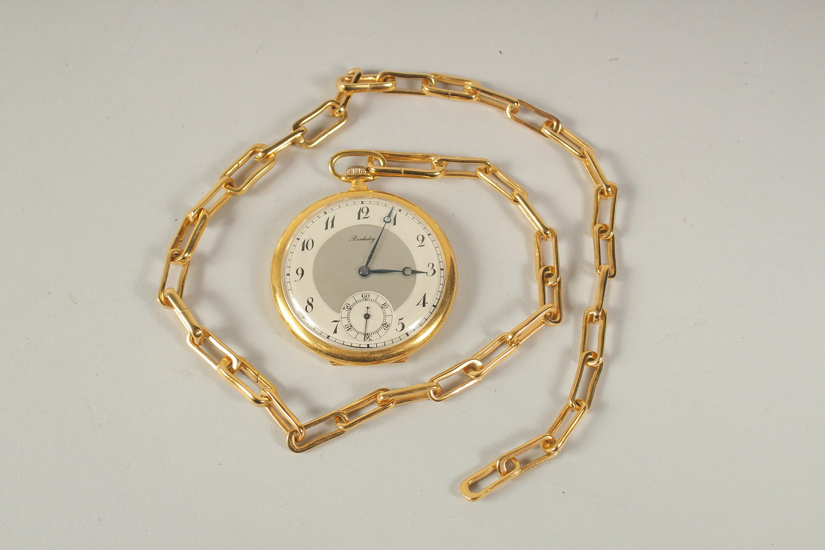 A BERKELEY GILT POCKET WATCH AND CHAIN.