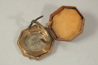 A GEORGIAN OCTAGONAL BRASS TRAVELLING COMPASS with silvered dial. Made in Paris. 3.75ins in a