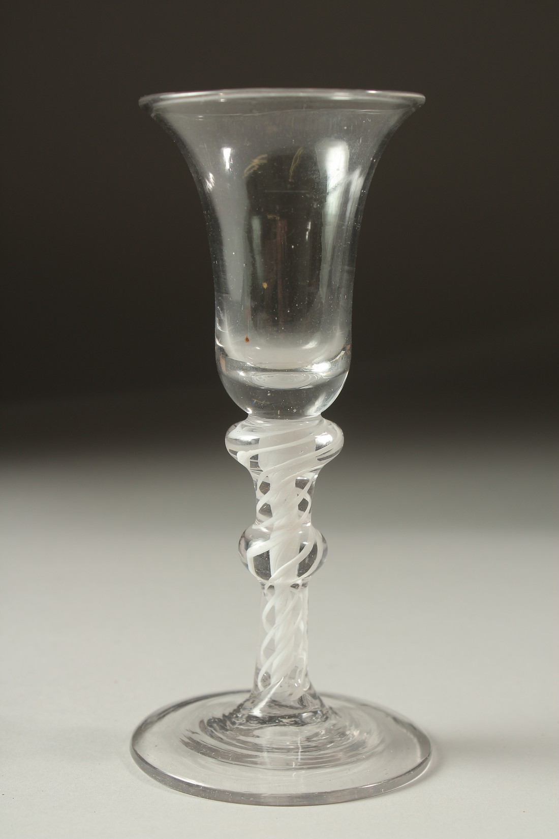 A GEORGIAN WINE GLASS with white opaque twist stem and single knop. 6ins high.