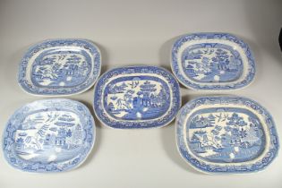 FIVE BLUE AND WHITE WILLOW PATTERN MEAT DISHES. 14ins long.