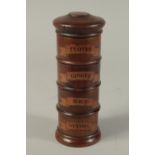 A WOODEN SPICE TOWER, cloves. ginger, mace and nutmeg. 8ins high.