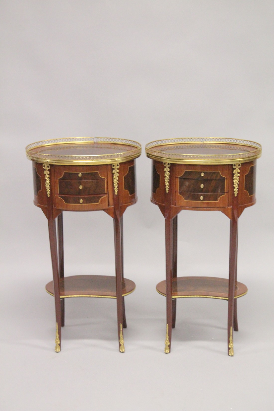 A PAIR OF LOUIS XVITH DESIGN INLAID OVAL BEDSIDE CUPBOARDS with three drawers, under tier and